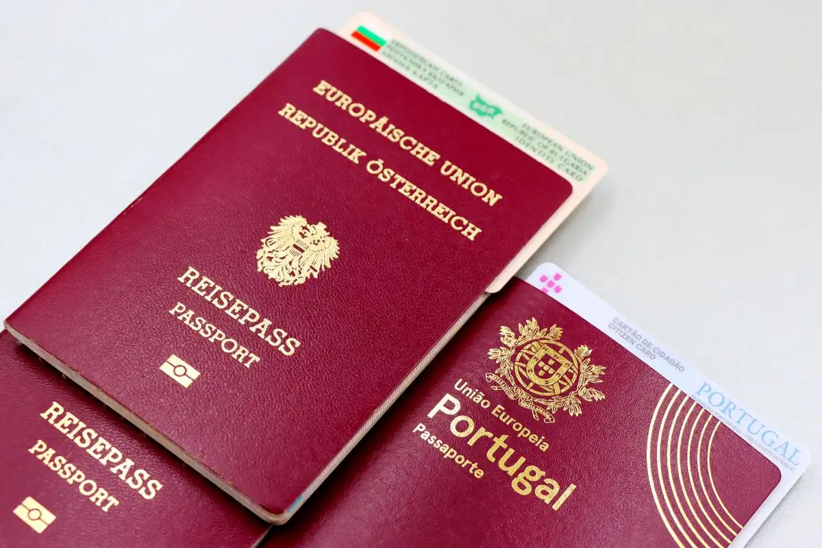 A passport resting on official paperwork on a desk
